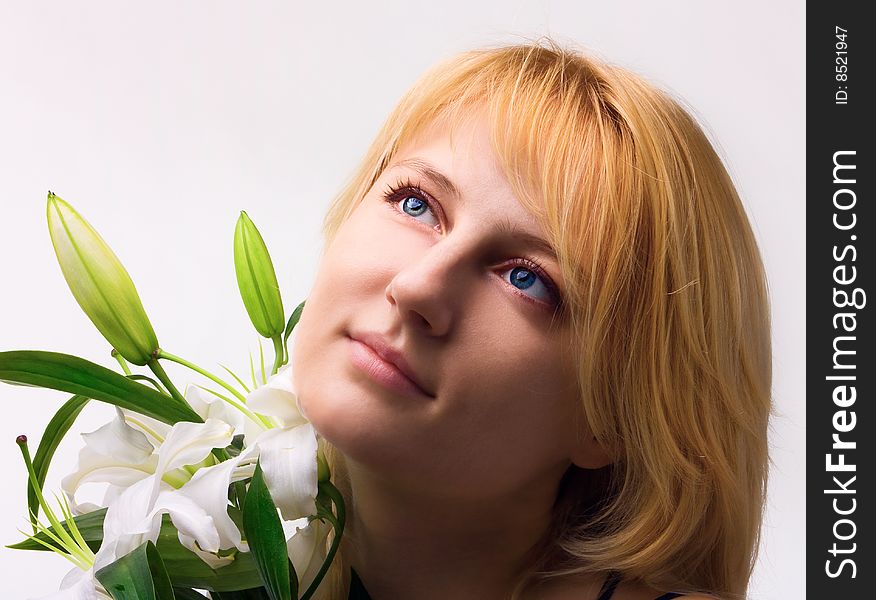 Beautiful young woman a blonde with lily flower. Beautiful young woman a blonde with lily flower