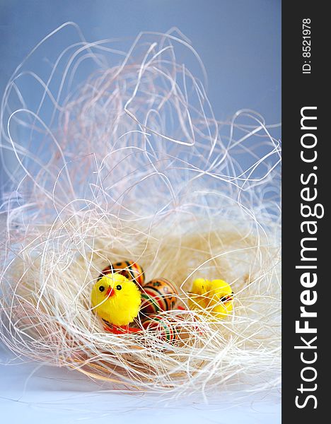 Easter background with decorative chickens and eggs are in a nests, enough space is for inscriptions