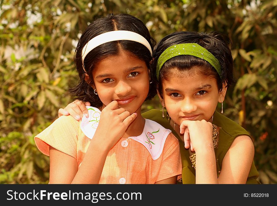 Two bright and beautiful girls actively listening the onlooker. Two bright and beautiful girls actively listening the onlooker.