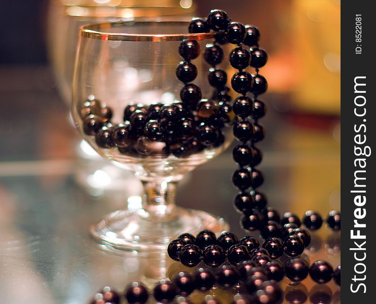 Still life, black beads lie in a stoup, small depth of sharpness. Still life, black beads lie in a stoup, small depth of sharpness