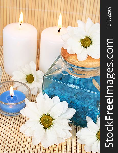 Candles, flowers and sea salt. Candles, flowers and sea salt