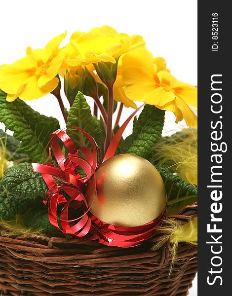 Golden egg with spring yellow flower for easter background.