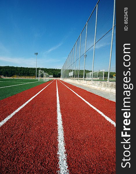 Running track and green football field. Running track and green football field