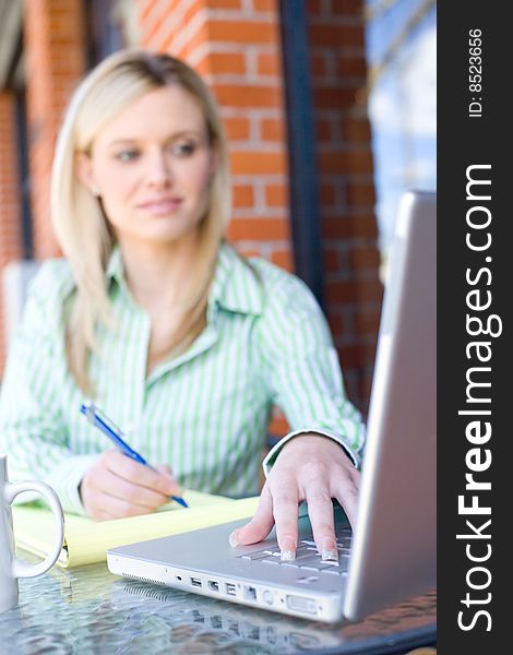 Business Woman sitting at a cafe working focus on hand