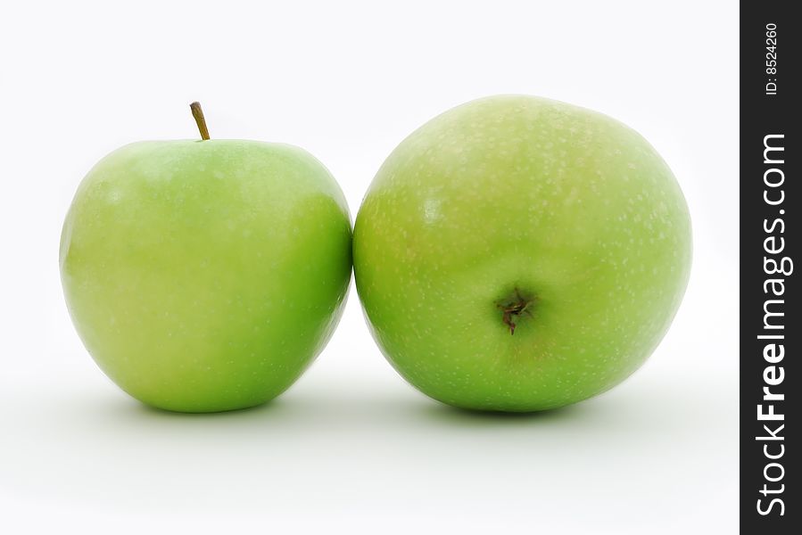 Two juicy green apples on a white background. Two juicy green apples on a white background