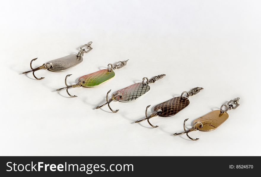 Spoon baits of the miscellaneous colour from metal with hook on white background