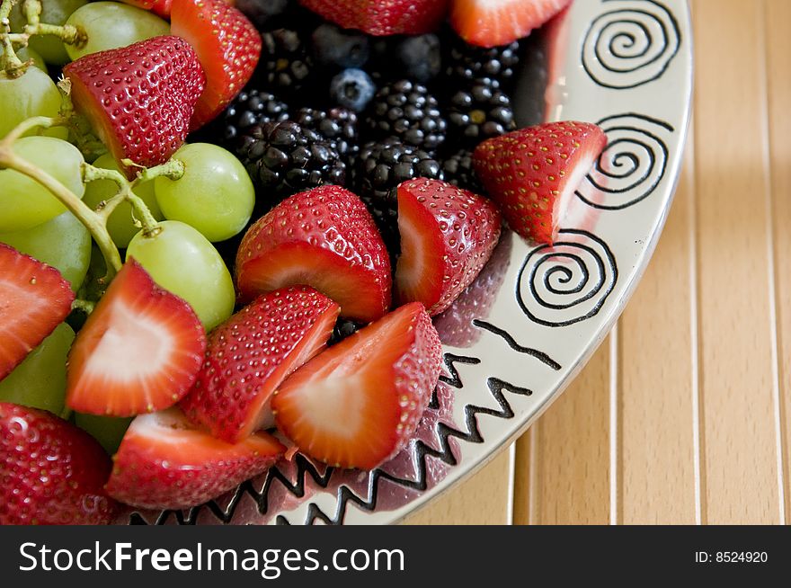 Fruit platter containing strawberries, blueberries, blackberries, and grapes. Fruit platter containing strawberries, blueberries, blackberries, and grapes.