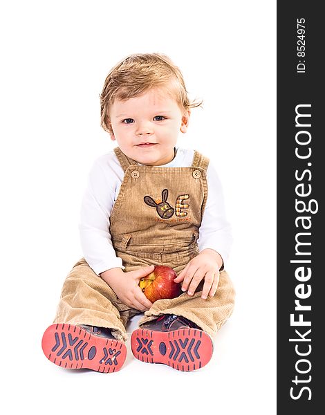 Sitting little boy holds on apple