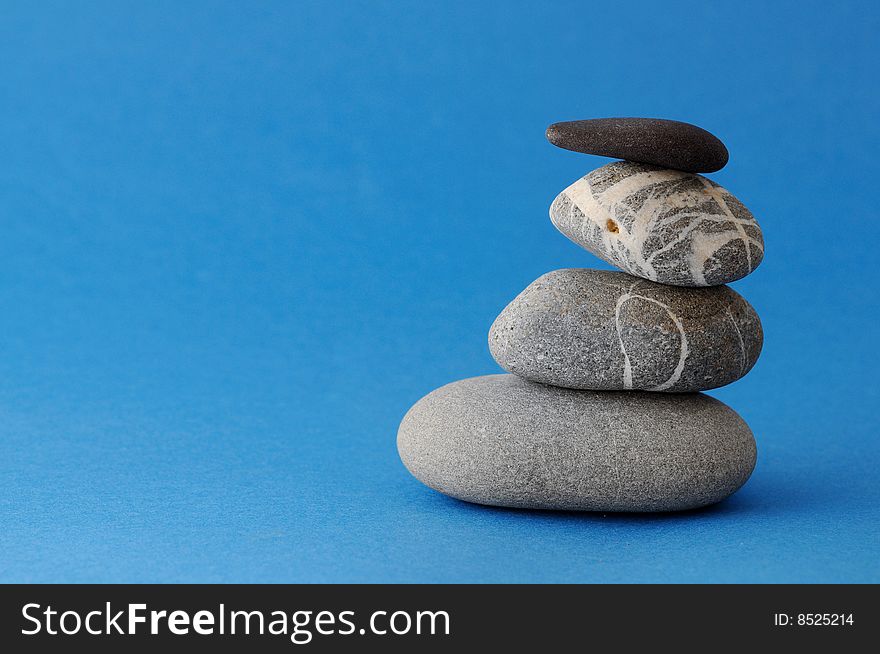 Spa stones on blue background