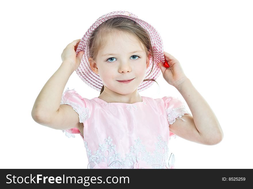Portrait of little blond girl in pink holding her hat