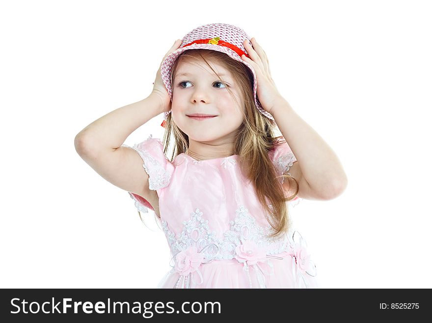 Smiling little girl in pink holding her hat