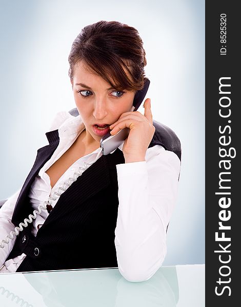 Front view of angry female corporate woman talking on phone with white background. Front view of angry female corporate woman talking on phone with white background