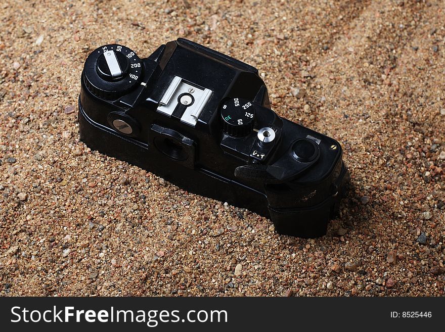 Film camera thrown to sand