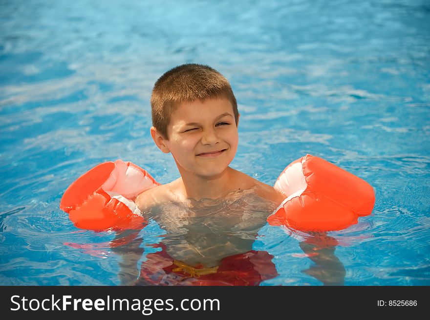 Portrait of the boy swims in the pool