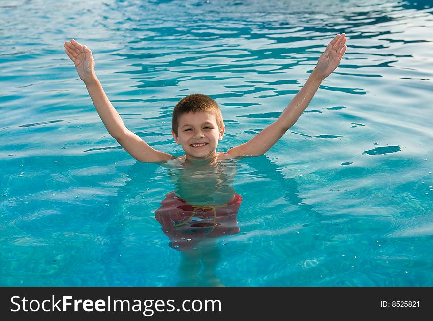 Young boy swims in the pool. Young boy swims in the pool