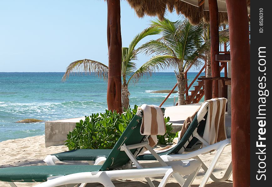 These beach chairs and towels are ready and waiting for the tourist to relax and sun bathe on the mexican riviera.