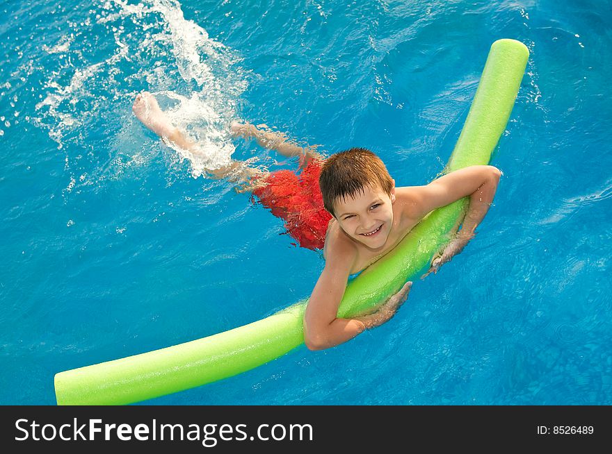 Young boy swims in the pool. Young boy swims in the pool