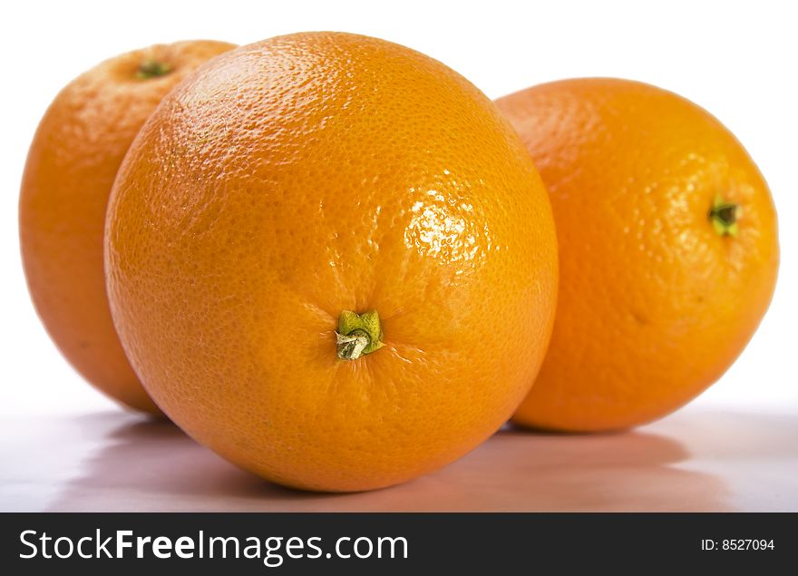 Close up of three fresh oranges on white background. Close up of three fresh oranges on white background