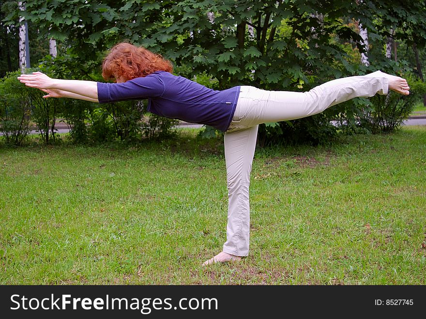 Young girl doing yoga on the nature