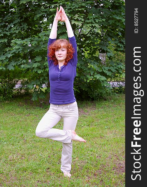 Young girl doing yoga on the nature