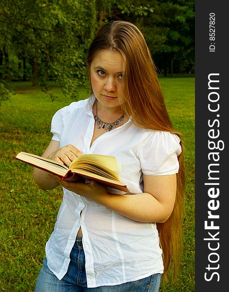 Blond girl standing with a book. Blond girl standing with a book