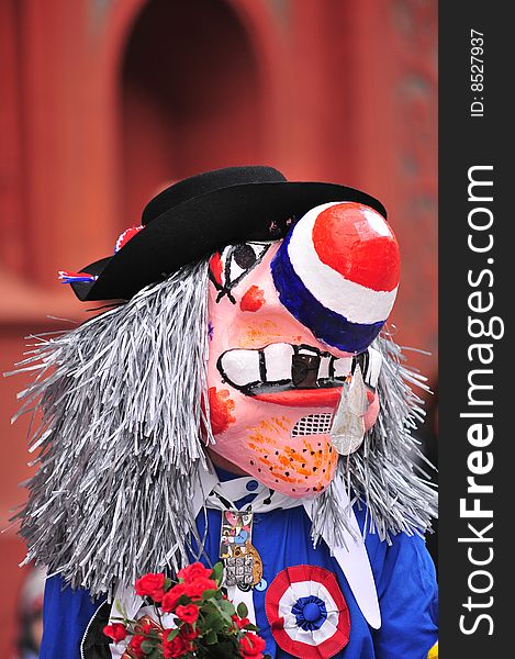 Close up of person wearing traditional waggis mask at Basel carnival, Switzerland. Close up of person wearing traditional waggis mask at Basel carnival, Switzerland.