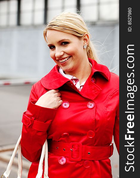 Beautiful blonde woman in red coat