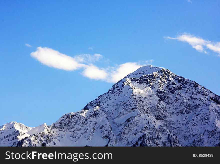 Snowy mountain top with blue sky