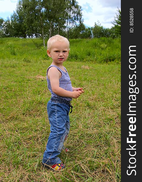 Angry boy standing in the field