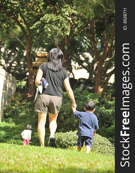 A family goes for a walk in a lush green area. A family goes for a walk in a lush green area