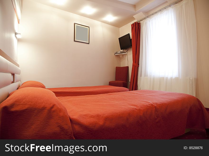 Hotel room with red and beige four stars empty