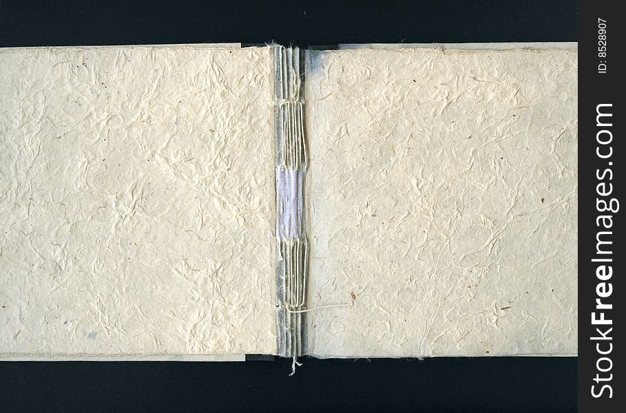 Handmade blank book with broken spine on black background. Handmade blank book with broken spine on black background