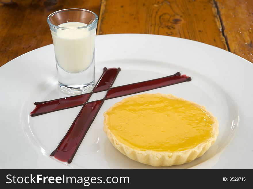 Delicious lemon tart with cream jar and decoration on plate