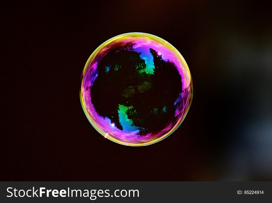 A colorful soap bubble floating in mid air.