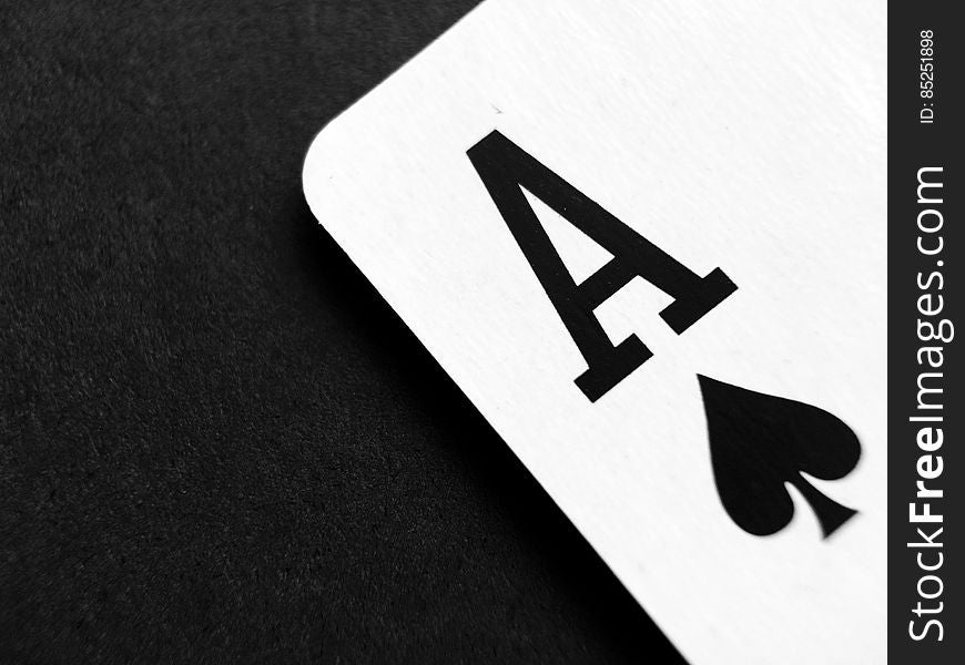 A close up of an ace playing card on a black background.