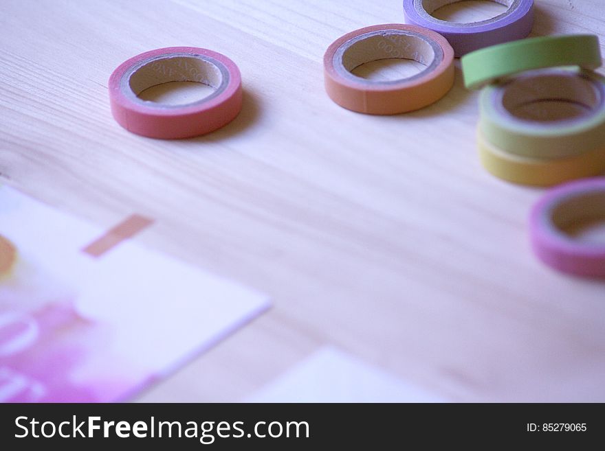 Rolls of colorful artist adhesive tape on wooden tabletop. Rolls of colorful artist adhesive tape on wooden tabletop.