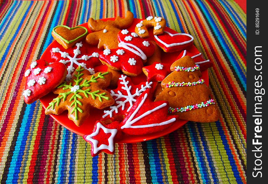 Decorated Christmas handmade cookies on a colorful tablecloth. Decorated Christmas handmade cookies on a colorful tablecloth.