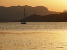 Sunset Over A Sail Boat On The Sea Stock Images