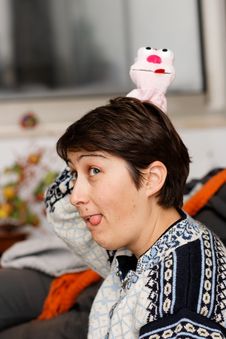 Young Woman Sticks Out Her Tongue Royalty Free Stock Images