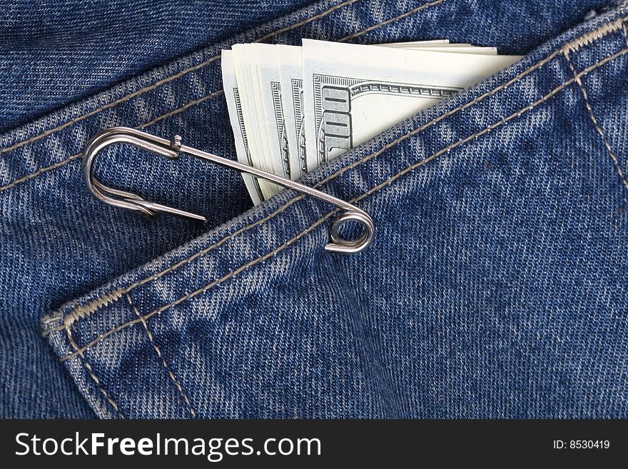 Jeans pocket with pack of one hundred dollar's notes. Jeans pocket with pack of one hundred dollar's notes