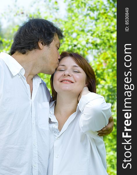 Portrait of young happy couple in summer environment. Portrait of young happy couple in summer environment