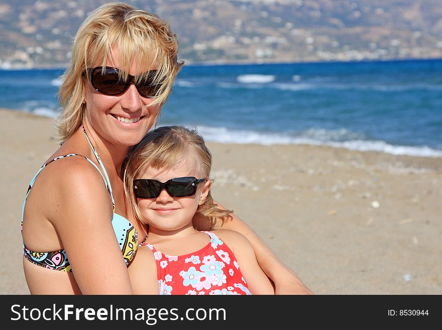 Happy mum with a daughter have a rest on the sea