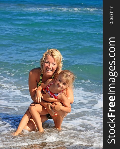 Happy Mum With A Daughter Have A Rest On The Sea