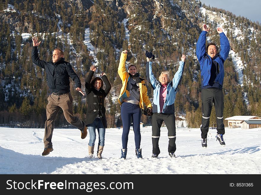 Family in a and outdoor winter setting. Jumping in joy! Slight motion bluriness is intended. Family in a and outdoor winter setting. Jumping in joy! Slight motion bluriness is intended.