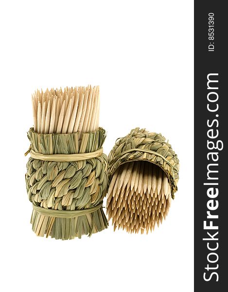 Bamboo toothpicks in a wum basket isolated on a white background