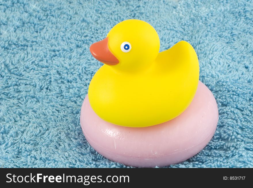 Classic rubber ducky on a pink bar of a scented soap