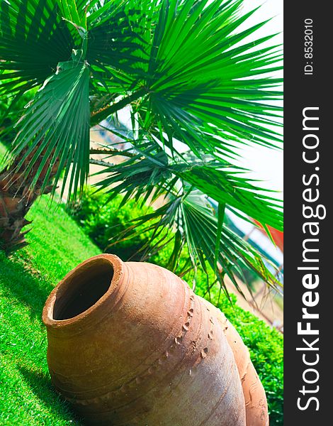 Large clay pitcher lying on grass. Large clay pitcher lying on grass