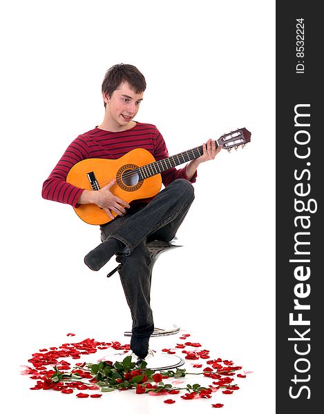 Casual dressed teenager, surrounded with rose petals. studio shot. Casual dressed teenager, surrounded with rose petals. studio shot.