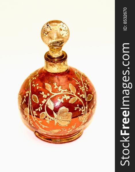 Red and gold glass bottle with leaves