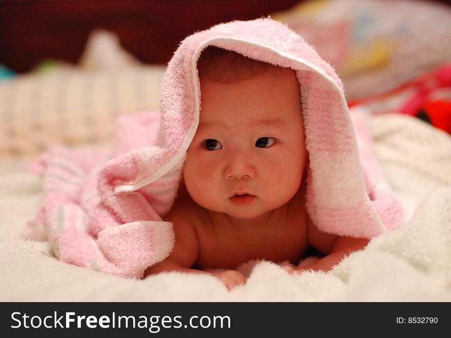 adorable baby boy over white quilt. adorable baby boy over white quilt